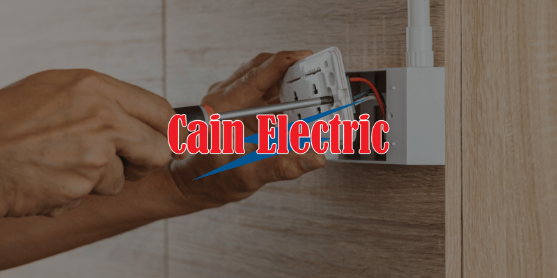 an electrician installing a wall outlet