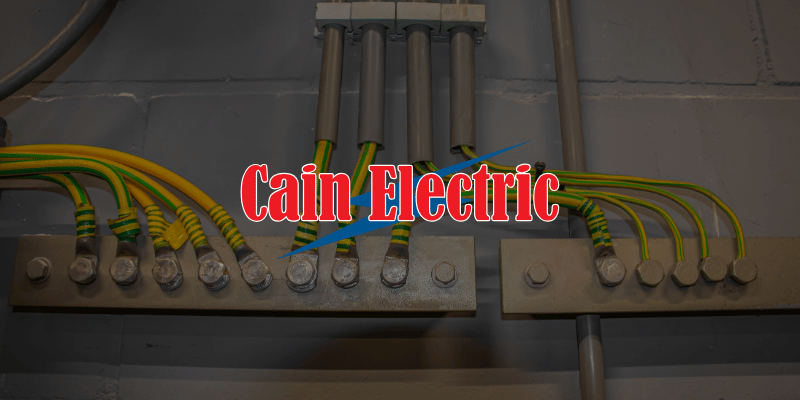 a series of grounding wires against a painted brick wall