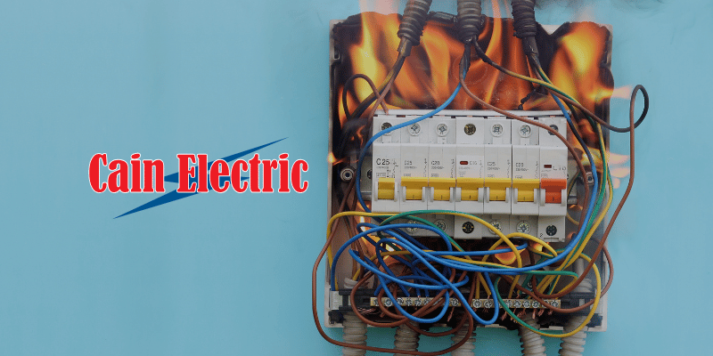 An outdated electrical circuit breaker which is on fire